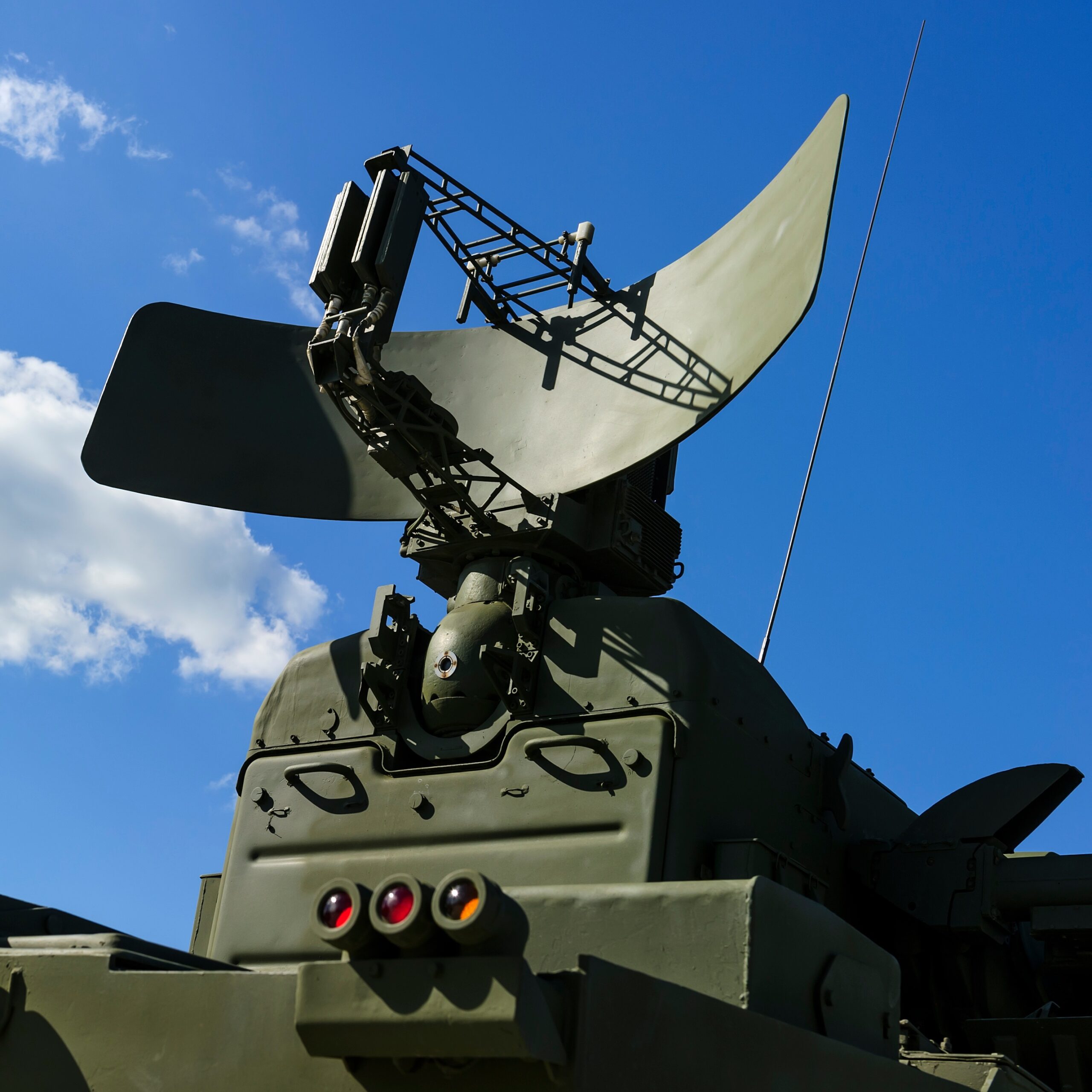 Radar system installed on a green military vehicle.